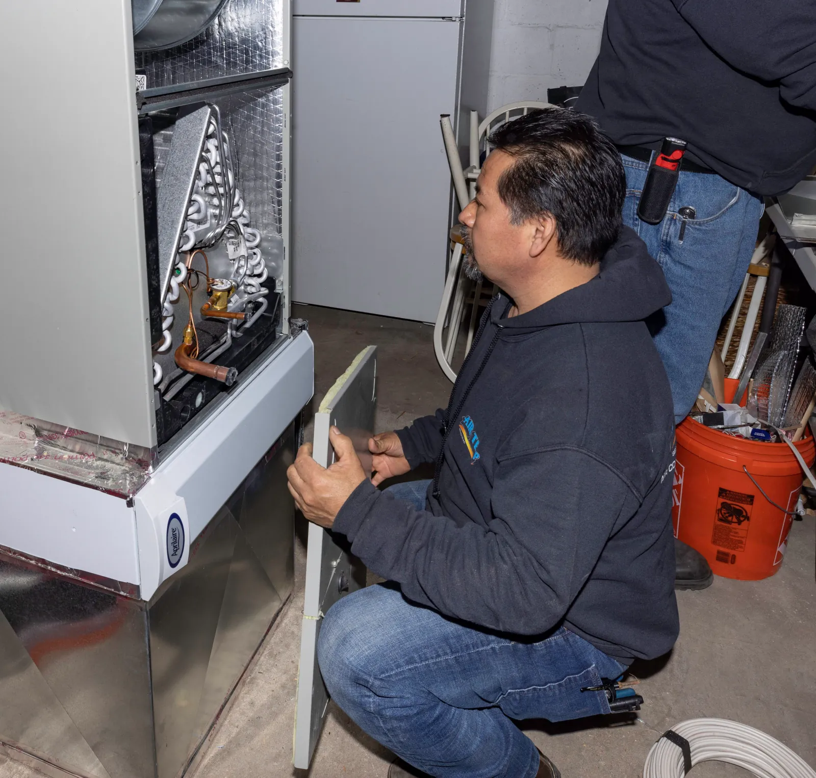 North Jersey furnace repair technician inspecting gas furnace during seasonal maintenance service