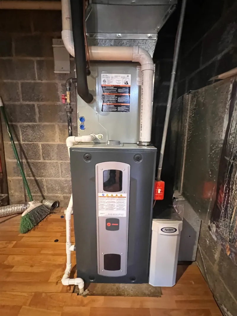 Trane high-efficiency gas furnace installation with Aprilaire air purifier in North Jersey basement